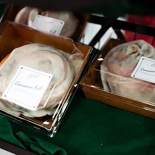 Fresh-baked cinnamon rolls packaged at the Emerald House bakery booth