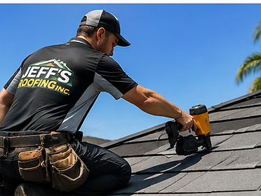 Roofer using a pneumatic nail gun to install asphalt shingles on a sloped roof