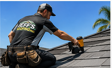 Roofer using a pneumatic nail gun to install asphalt shingles on a sloped roof