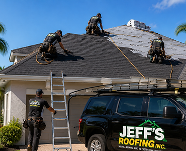 Jeff's Roofing crew installing shingles on a residential roof with company truck