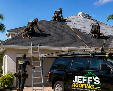 Jeff's Roofing crew installing shingles on a residential roof with company truck