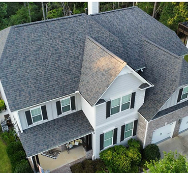 Aerial view of a completed residential roof replacement on a two-story suburban home