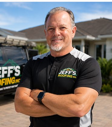 Jeff's Roofing owner posing with arms crossed beside the company truck