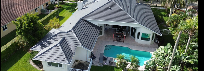 Aerial view of a completed residential roof with pool
