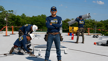 Jeff's Roofing commercial crew working on a flat membrane roof