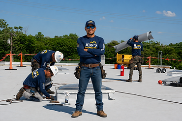 Jeff's Roofing commercial crew working on a flat membrane roof