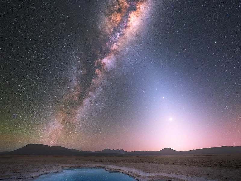 Milky Way arching over a still pool in the desert at night