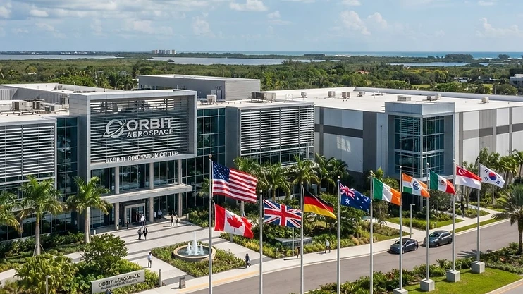 Modern aerospace facility in Melbourne, Florida with international flags.