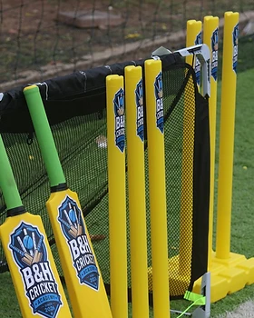 B&H Cricket Academy stumps and bats on the turf