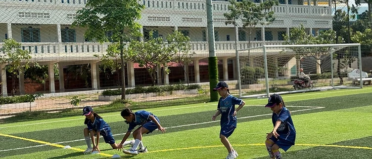 Young players running a training drill on the turf