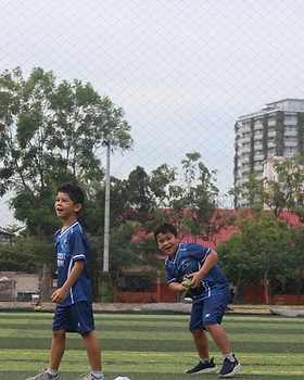 Two young players smiling during training
