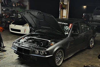 BMW in the garage, hood open