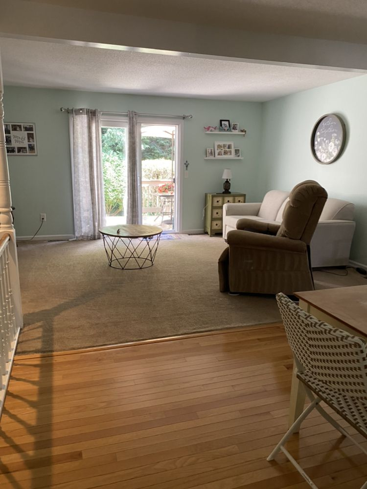 A bright, tidy living room cleaned by Elegant House Cleaning Services