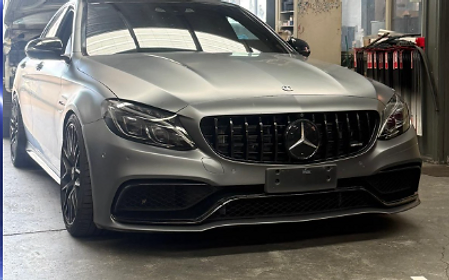 Grey Mercedes-AMG sedan inside the Karims workshop