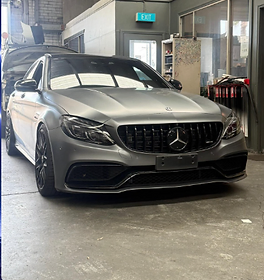 Grey Mercedes-AMG sedan inside the Karims workshop