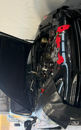 Engine bay open with protective cloths during a service