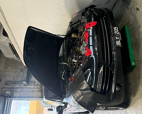 Engine bay open with protective cloths during a service