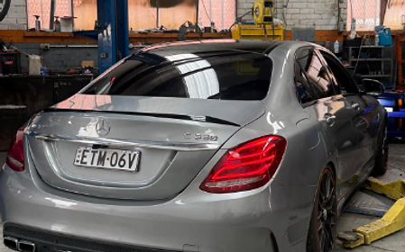Silver Mercedes-AMG C63s rear quarter inside the workshop