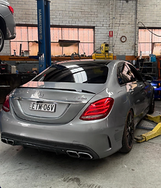 Silver Mercedes-AMG C63s rear quarter inside the workshop