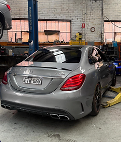 Silver Mercedes-AMG C63s rear quarter inside the workshop