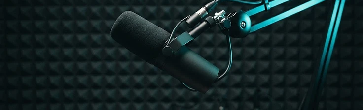 Professional podcast studio with cyan lighting