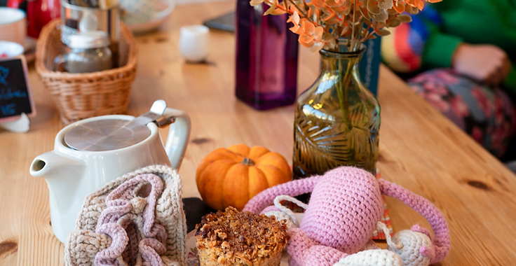 A Fannies & Flapjacks table set with coffee, cake and crocheted treats