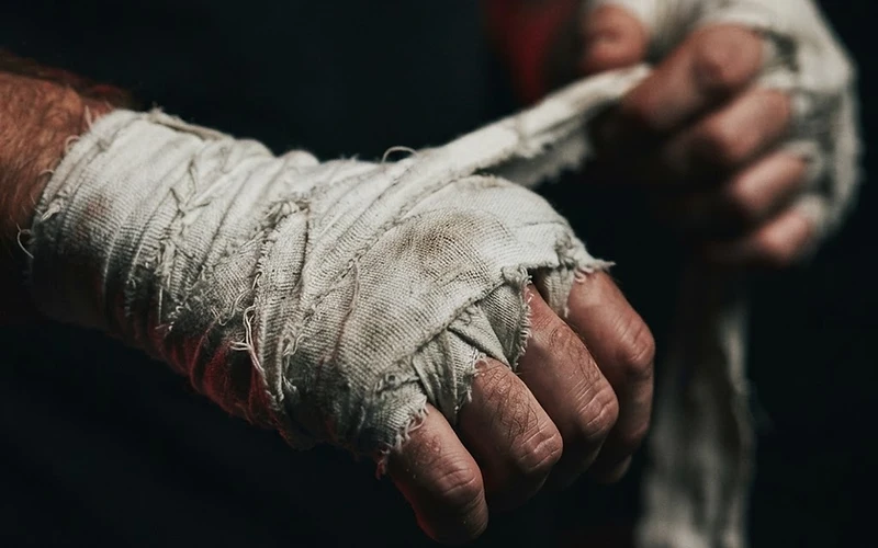 Close-up of martial arts hand wraps being tightened