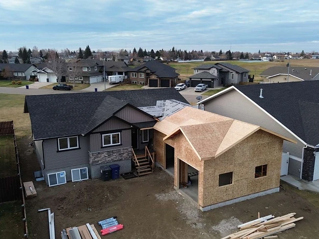 Elevated view of attached garage with roof and wall sheathing in place