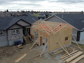 Elevated view of attached garage with exposed roof framing