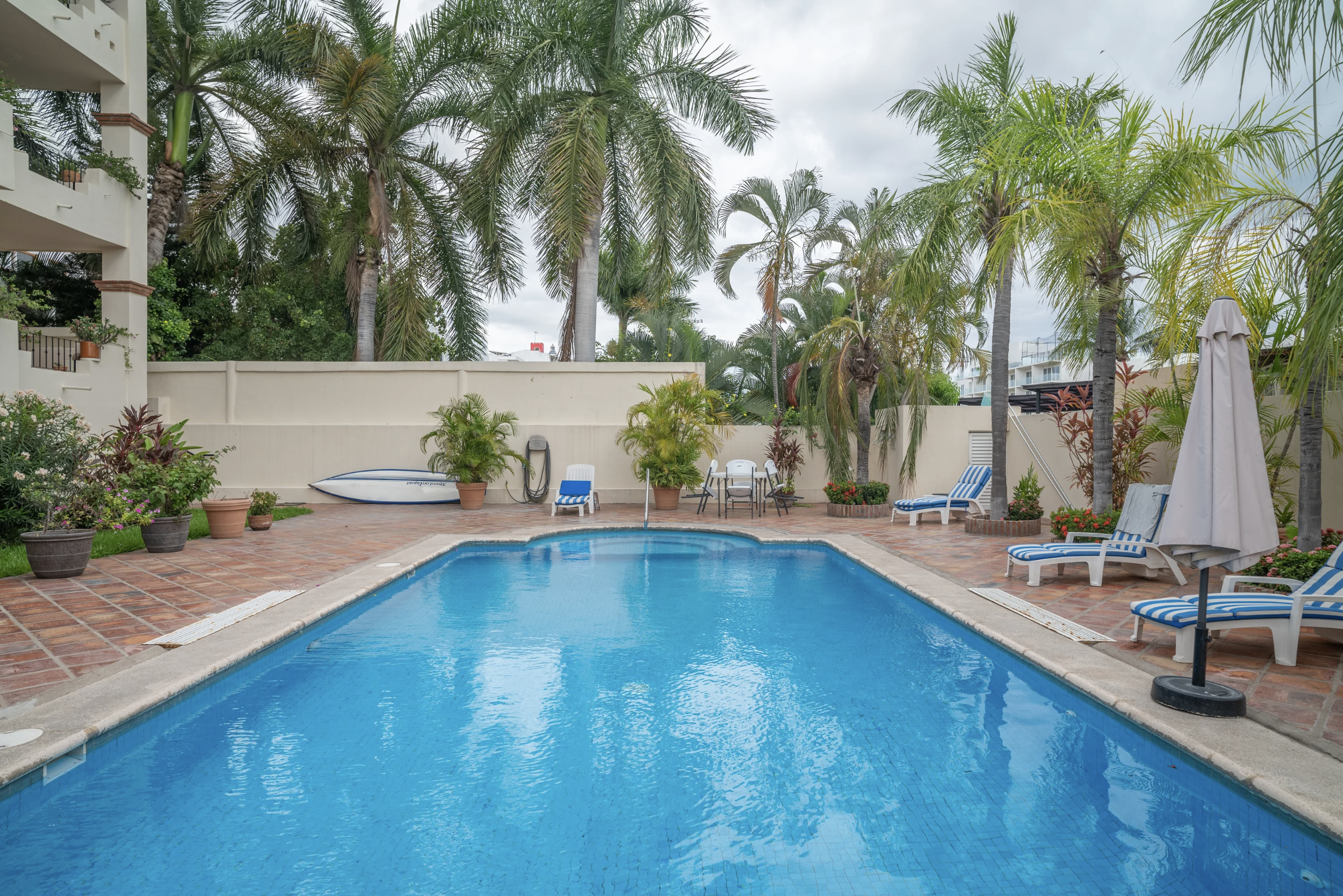 Condominium swimming pool with lounge chairs