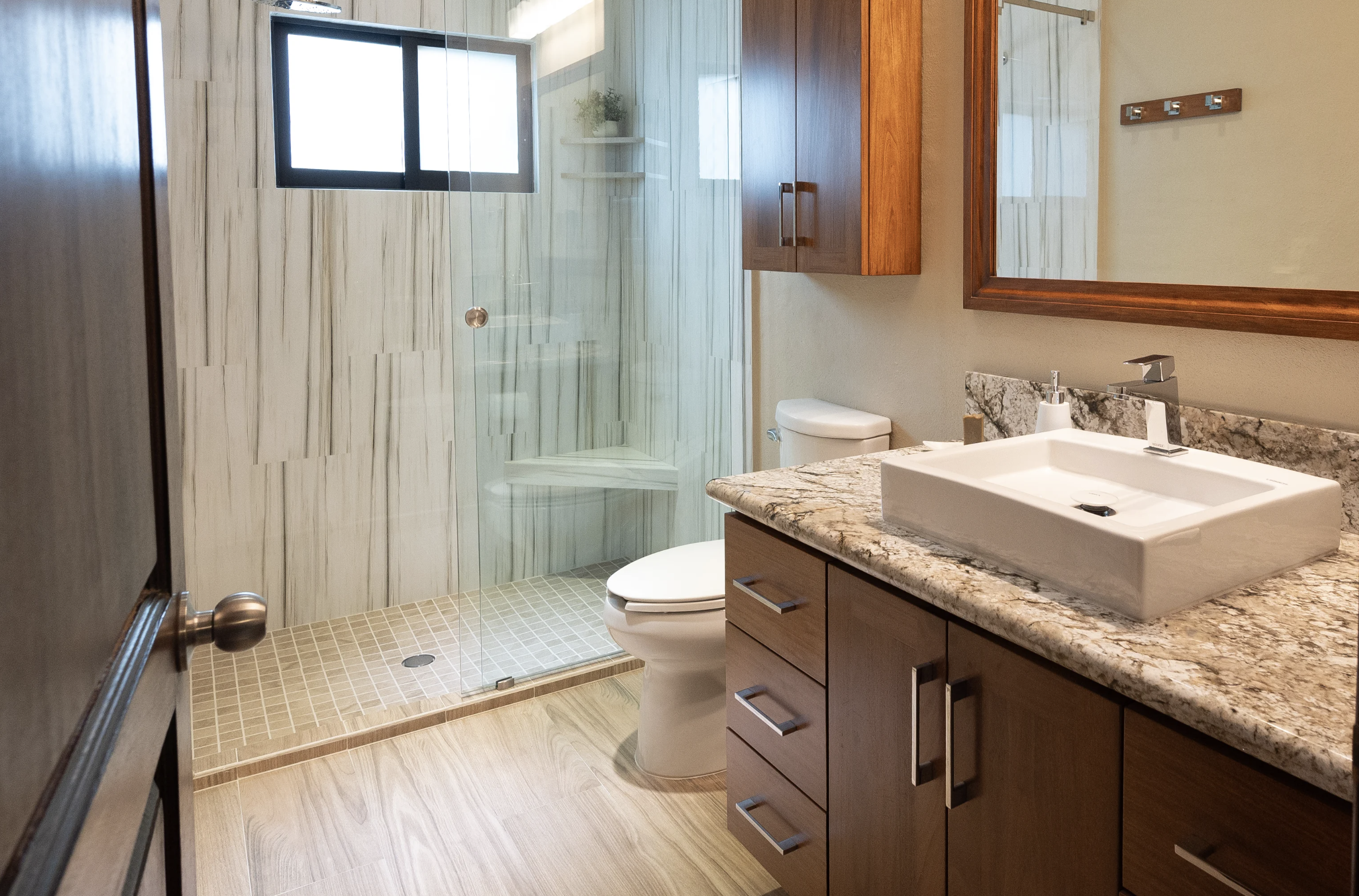 Renovated bathroom with frameless glass shower