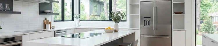 Clean residential kitchen with stainless steel refrigerator