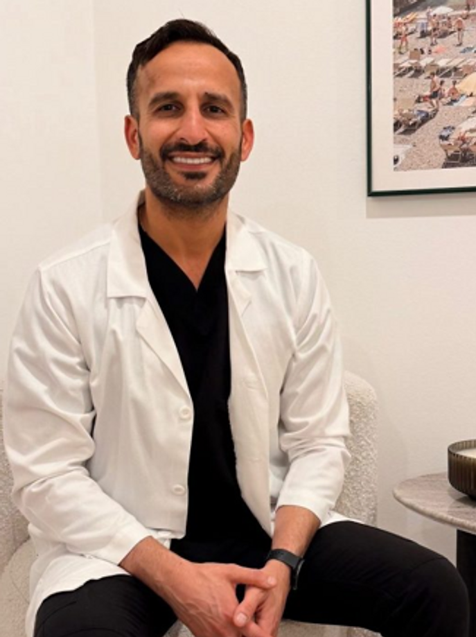 Dr. Michael Ghermezi, MD, seated in the office