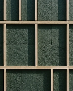 Architectural texture of clean geometric lines and deep forest green stone