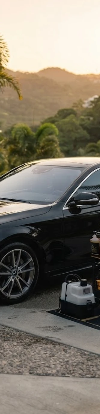 Mobile detailing service beside a luxury vehicle in Caguas