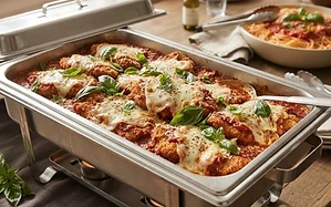 Catering tray of chicken parmesan cutlets with marinara and melted cheese