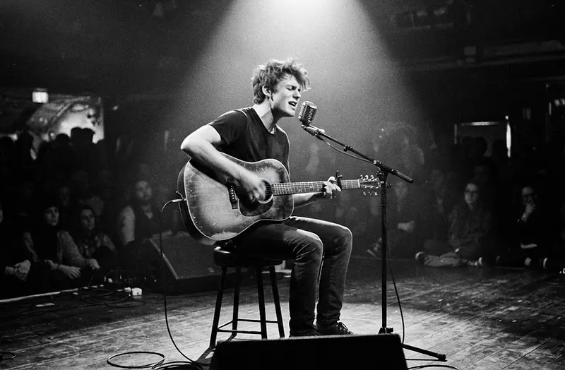 Student performing on stage, monochrome