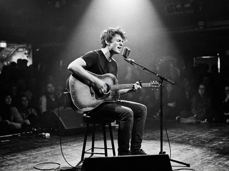 Student performing on stage, monochrome