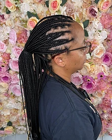 Cornrows swept into a low ponytail, profile view
