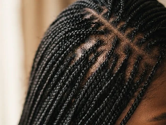Macro close-up of tiny delicate micro braids with fine precise parting
