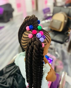 Braided mohawk updo swept into a twisted top bun with beads