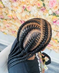 Curved cornrows converging into long straight braids