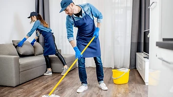 Professional cleaners mopping a residential living room floor