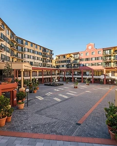 The open piazza with the red clock tower