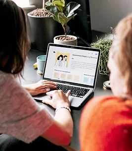 Two team members reviewing a project on a laptop during a working session