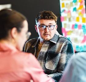 Team members in discussion during a meeting