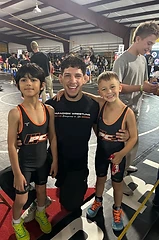 Coach with two youth wrestlers