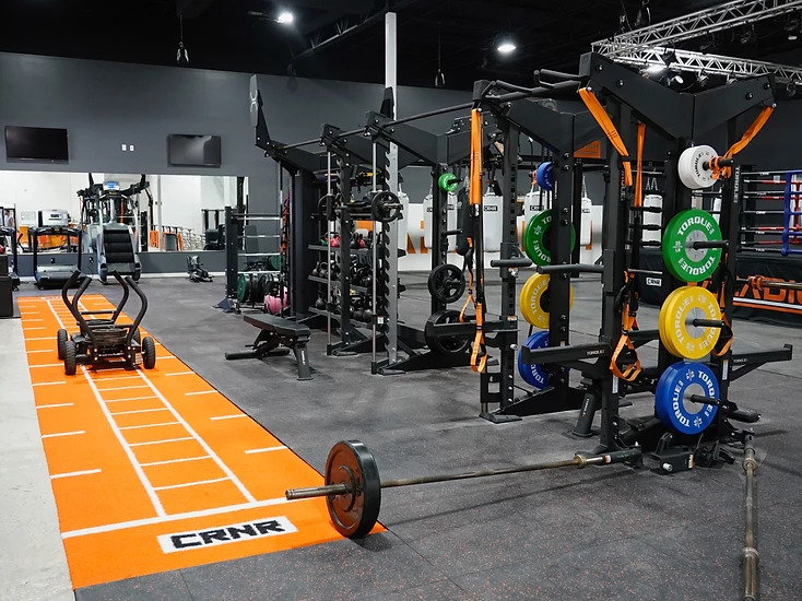 Paradigm® strength and conditioning floor with sled track and power rigs