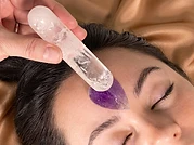 A Crystal Light Therapy session — crystals placed on the forehead during a treatment