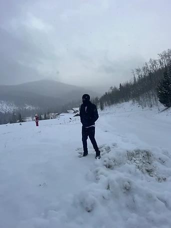 A lone figure standing in a snowy field